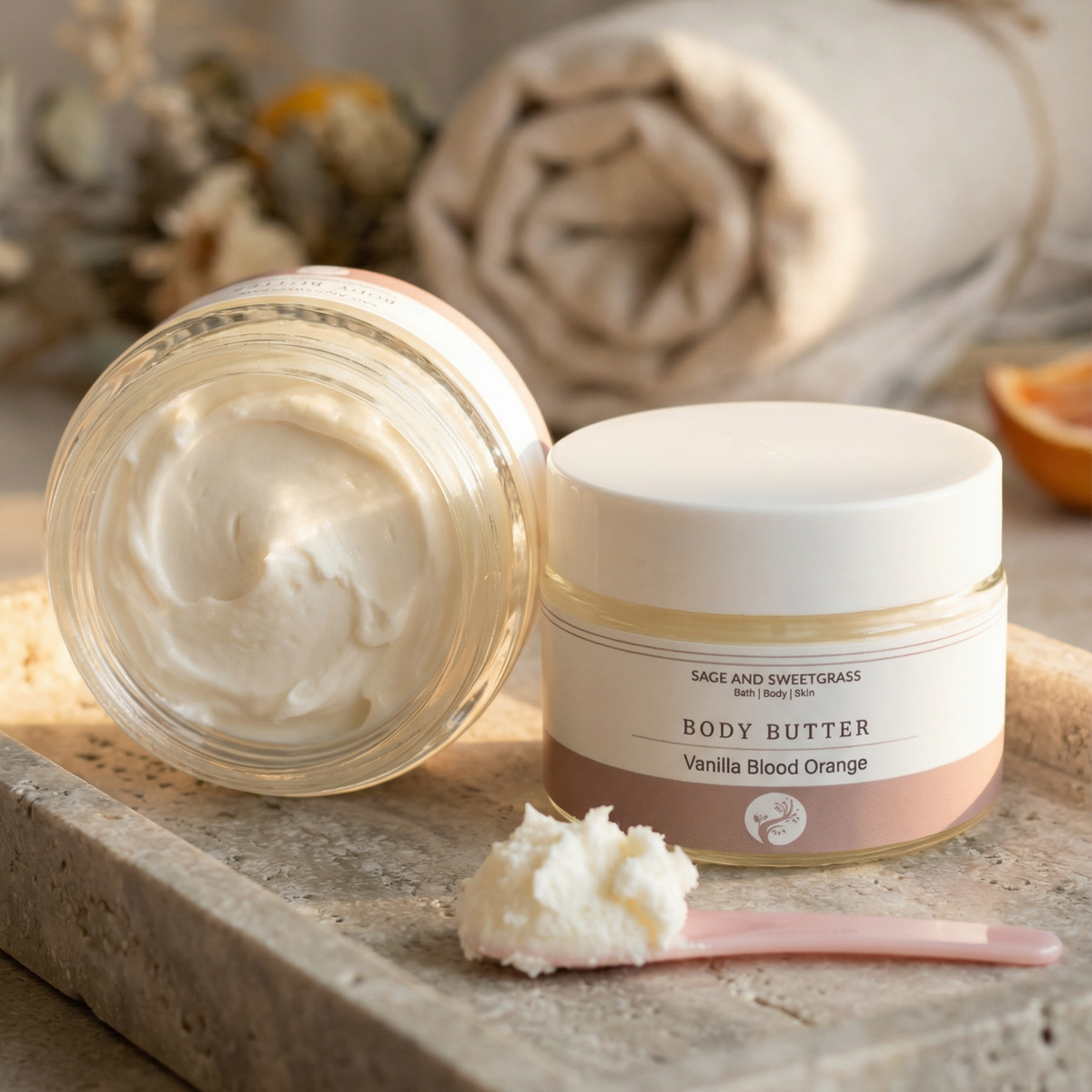 Body butter jar with a spoonful of cream on a stone surface